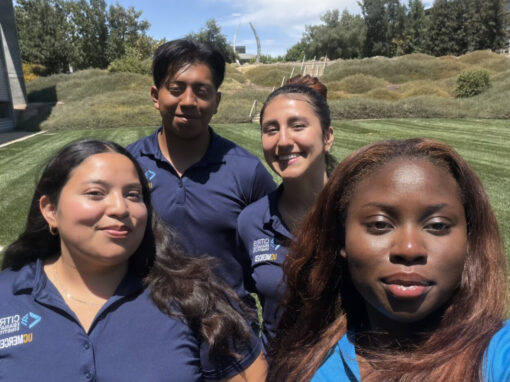 Photo of a group of four CITRIS interns standing on a grass field